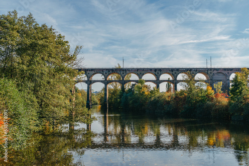 Railway Bridge with river in Bietigheim-Bissingen, Germany. Autumn. Railway viaduct over the Enz River, built in 1853 by Karl von Etzel on a sunny summer day. Bietigheim-Bissingen, Germany. Old