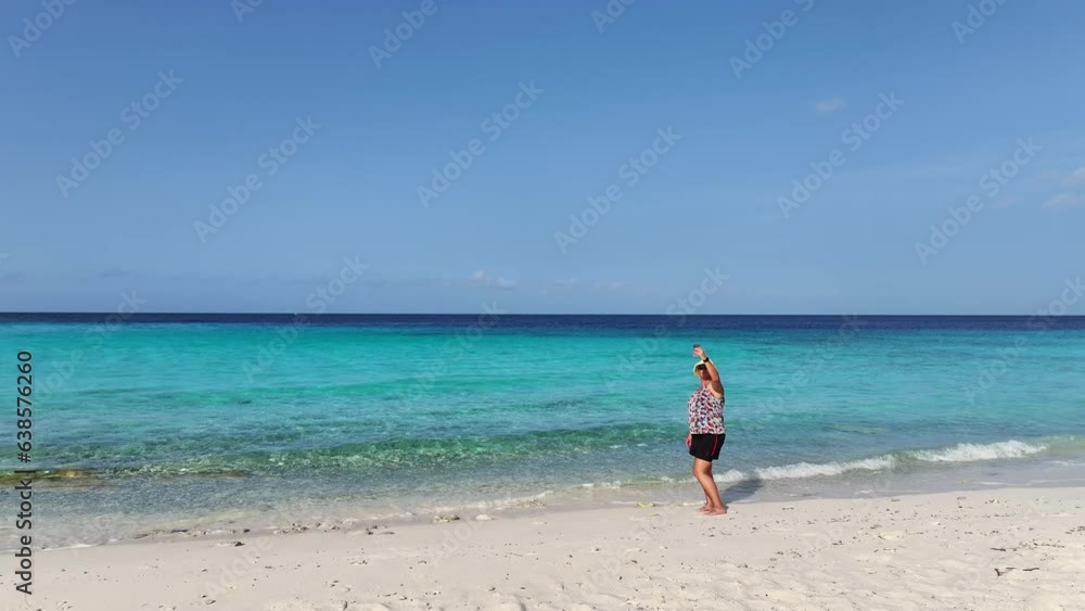 A woman on a white beach on a tropical island in the Caribbean A woman on a white beach on a tropical island in the Caribbean