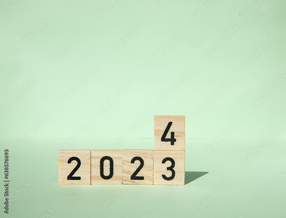 New Year 2024. wooden blocks of 2024 on a green background. Concept Start the new year by achieving your goals, new plans, strategies, new business, and improving the environment. end of 2023