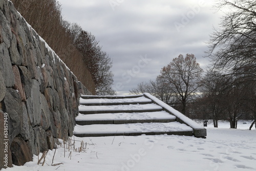 Stone staircase and wall. Snowy winter day.  photo