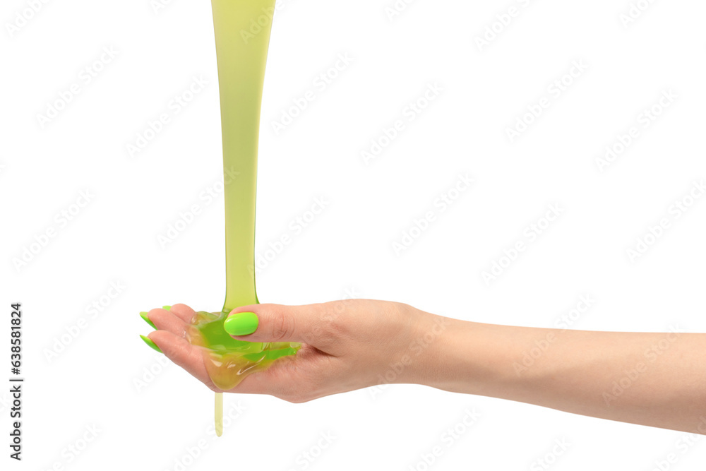 Green slime toy in woman hand with green nails isolated on a white background.