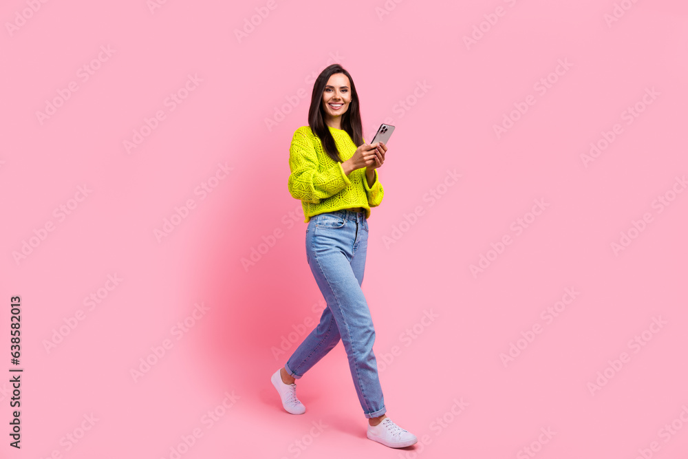 Photo of adorable positive cute lady wear denim stylish clothes walk street use gps navigation isolated on pink color background Photo of adorable positive cute lady wear denim stylish clothes walk street use gps navigation isolated on pink color background