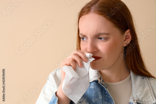 Allergic young woman sneezi...