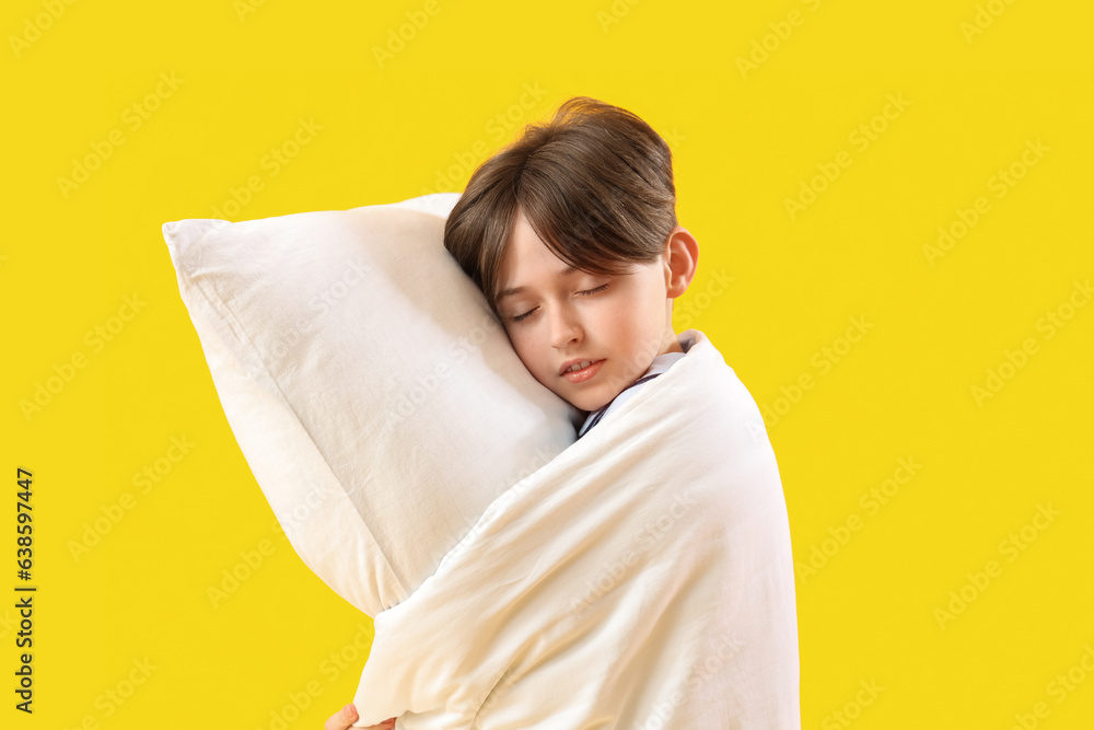 Sleepy little boy with pillow and blanket on yellow background Sleepy little boy with pillow and blanket on yellow background