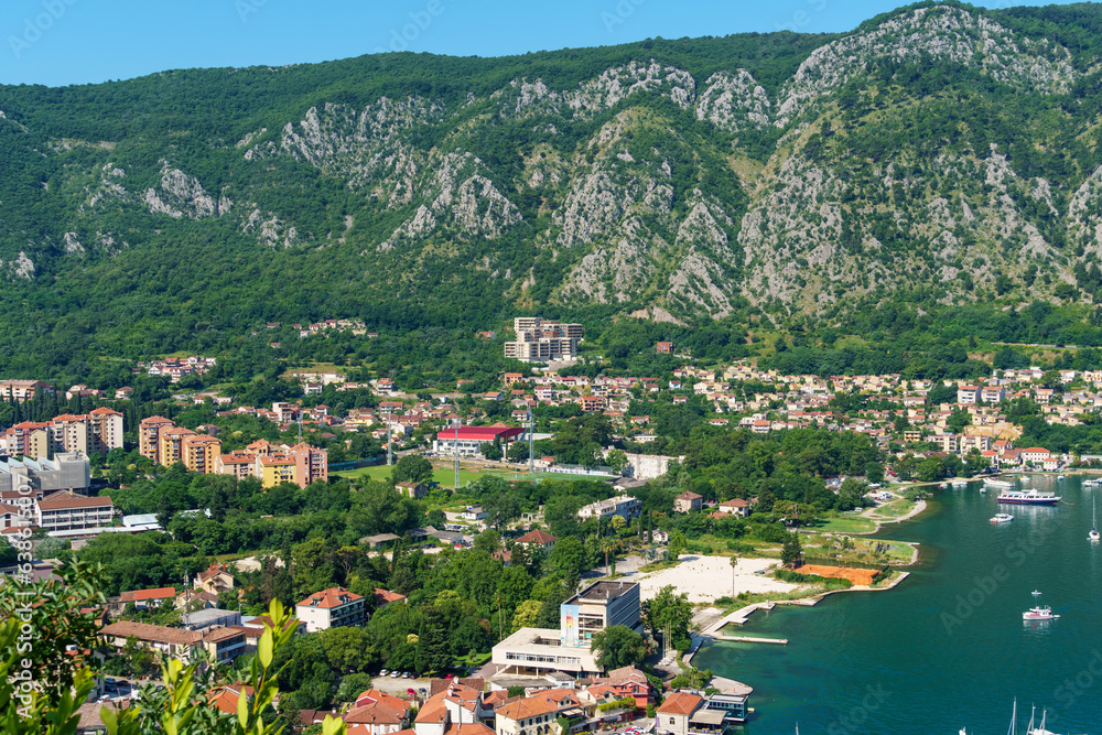 top view of the marina in Kotor, Montenegro, and the coast of the Bay of Kotor, the sea and European architecture, red tiled roofs, the concept of traveling in the Balkans