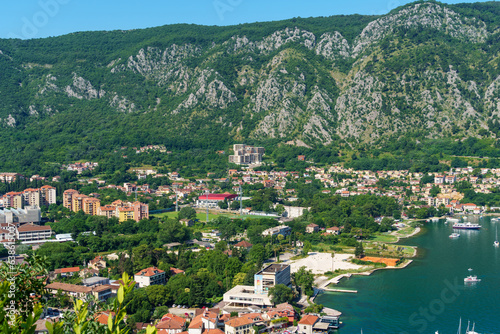 top view of the marina in Kotor, Montenegro, and the coast of the Bay of Kotor, the sea and European architecture, red tiled roofs, the concept of traveling in the Balkans