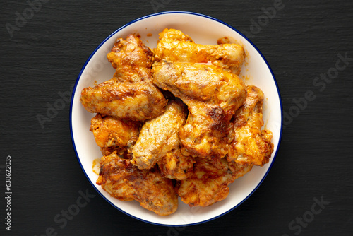 Homemade Rotisserie Chicken Wings with Smoked Paprika and Mayonnaise on a Plate, top view. Close-up.