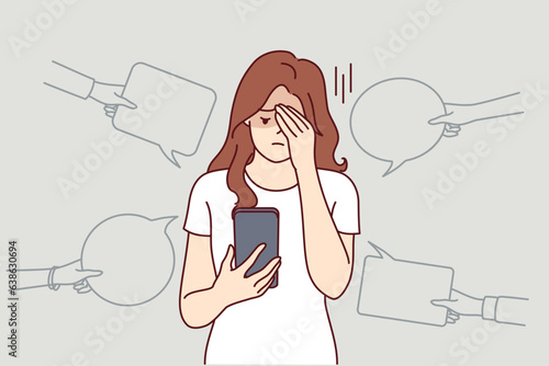 Upset woman with phone suffers from bullying and hate on social networks, receiving offensive messages and comments. Teenager girl is victim of internet bullying and discrimination from classmates