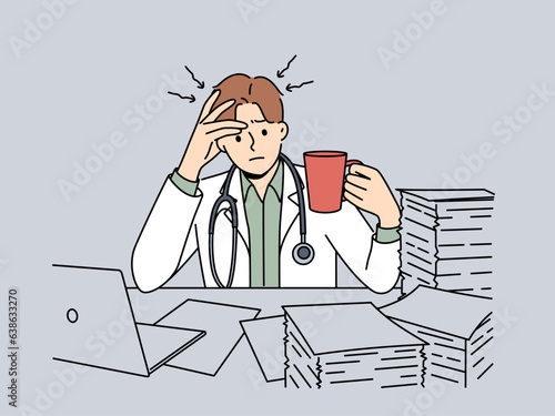 Frustrated doctor with cup of coffee sits at table with pile of papers and needs help of assistant. Concept of bureaucracy and overabundance of paperwork in doctor, causing apathy and burnout