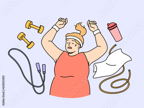 Fat woman lies on floor among fitness accessories, falling asleep after workout and dreaming of getting rid of overweight. Lazy girl does not want to go in for sports and fight overweight