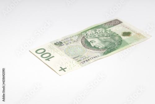 Polish banknote PLN lying on a white background (selective focus)