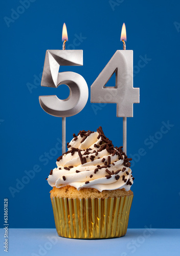 Burning candle number 54 - Birthday card with cake on blue Background