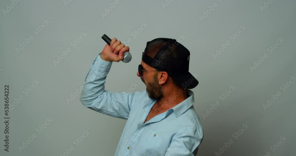 A middle-aged man dances and sings wildly in the studio A middle-aged man dances and sings wildly in the studio