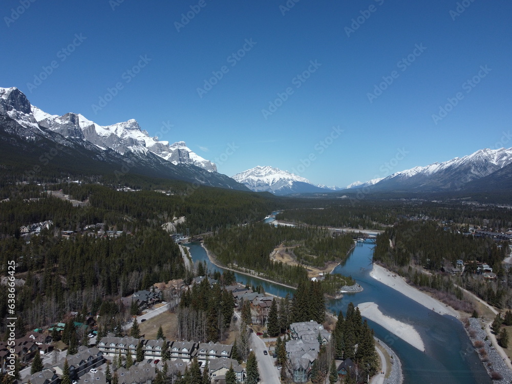 Aerial view of countryside in Alberta with river and mountain at distance