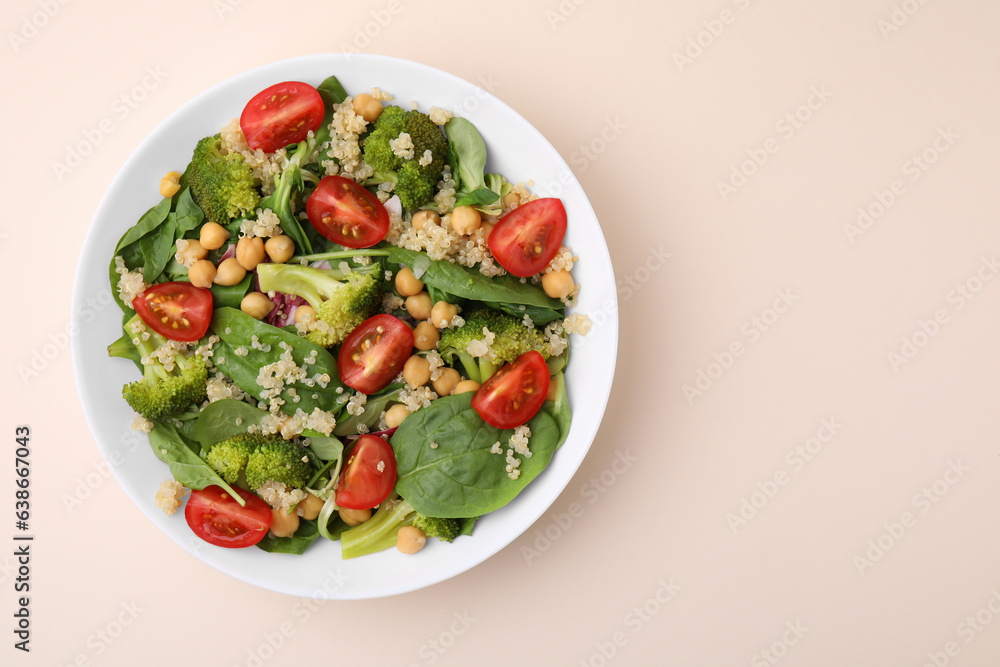 Healthy meal. Tasty salad with quinoa, chickpeas and vegetables on beige table, top view with space for text