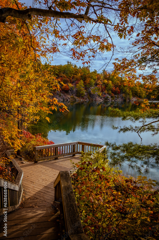 Fototapeta premium View of staircase during autumn, Fall foliage around Pink Lake in Gatineau Park, Quebec, Canada. Photo taken in October 2022.