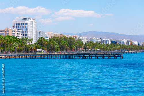 Palm trees and wooden pier in Limassol city, Cyprus