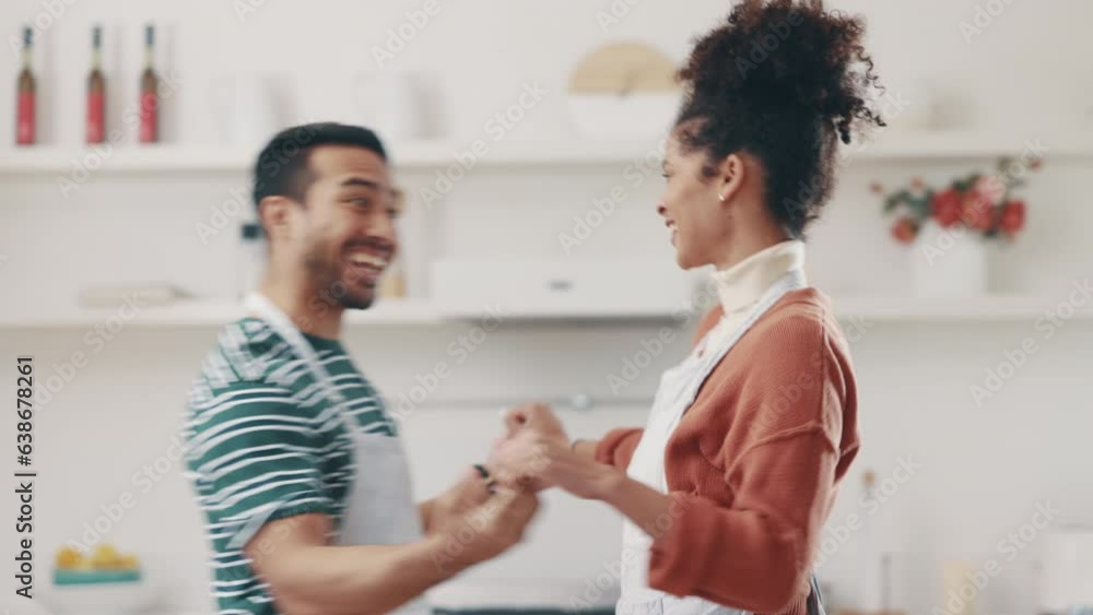 Love, smile and couple dance in the kitchen while cooking, bonding and having fun together. Happy, romance and young man and woman moving to music, playlist or radio and preparing dinner meal at home Love, smile and couple dance in the kitchen while cooking, bonding and having fun together. Happy, romance and young man and woman moving to music, playlist or radio and preparing dinner meal at home
