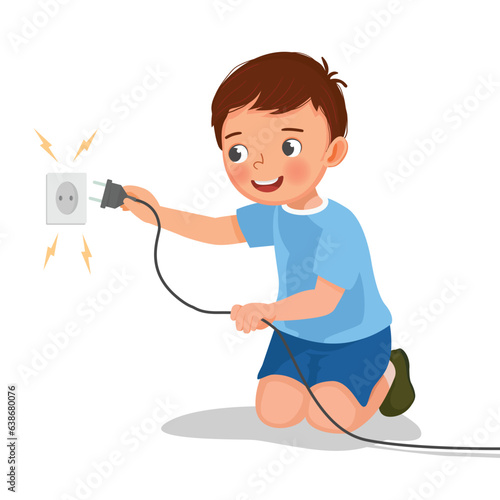 Little boy play with electricity put a plug into socket