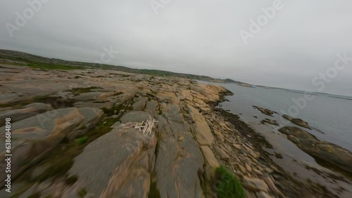 Drone flight passing low over rocky surface of Ramsvik coastline in Sweden photo