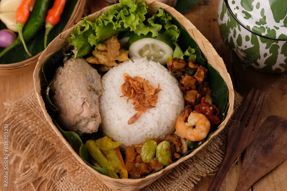Nasi Berkat Pekalongan. is rice with side dishes of fried chicken, stir