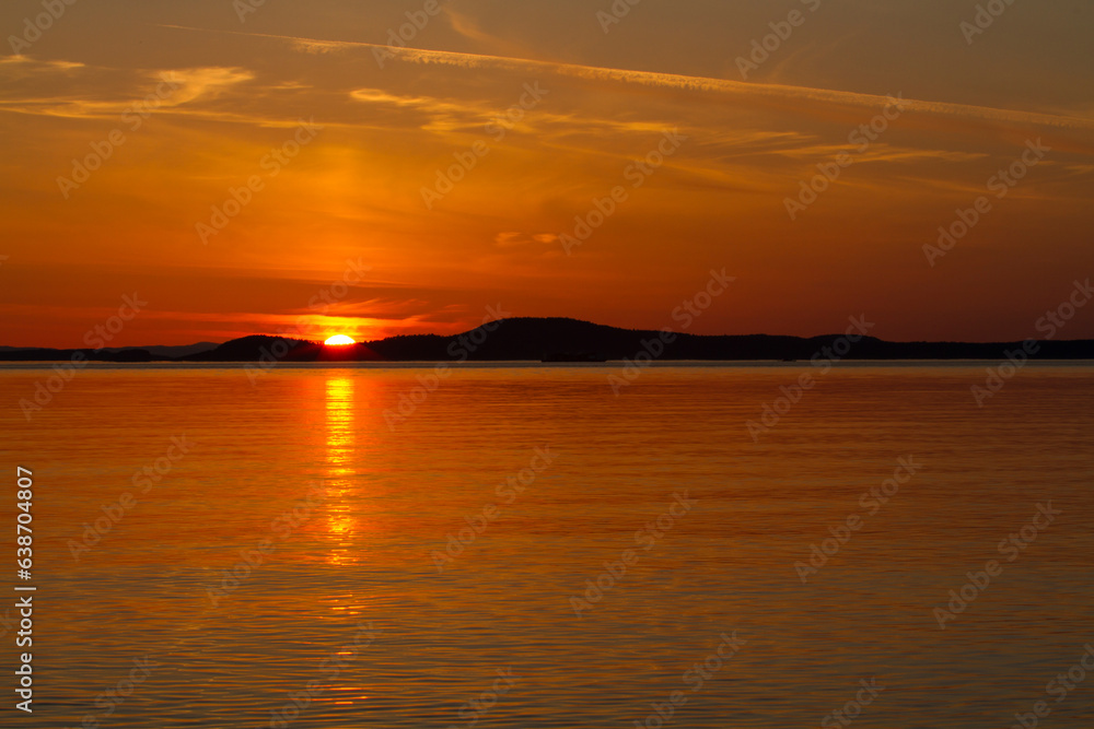 Orange Sunset over Tranquil Sea with Reflection Orange Sunset over Tranquil Sea with Reflection
