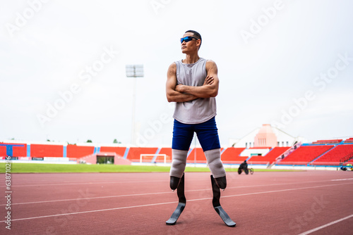 Asian para-athletes disabled with prosthetic blades standing at stadium.  photo