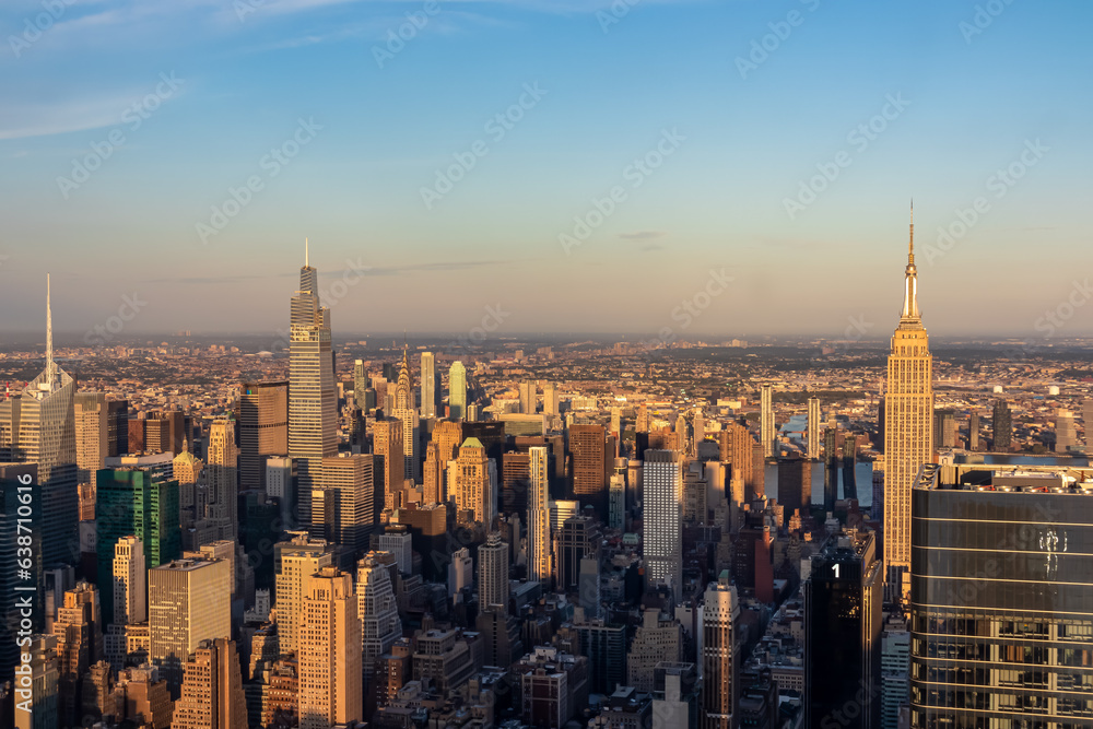 Captivating aerial view of New York City skyline during the dusk seen from The Edge. The buildings are shimmering with sunset colors. Endless rows of tall buildings. Bustling city. Endless horizon