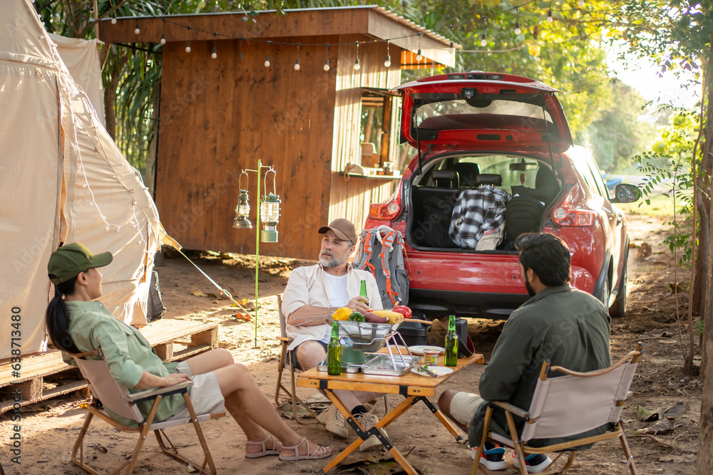 Group tourists drinking beer-alcohol and play guitar together with enjoy and happiness in Summer while camping Group tourists drinking beer-alcohol and play guitar together with enjoy and happiness in Summer while camping