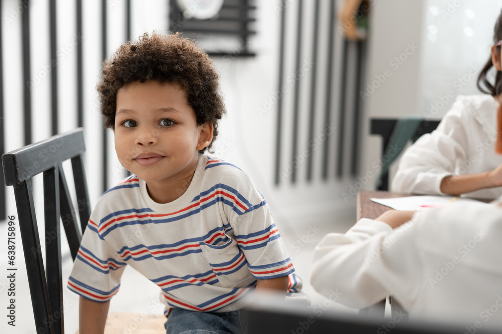 Happy African American kid boy studying with friend in classroom Happy African American kid boy studying with friend in classroom