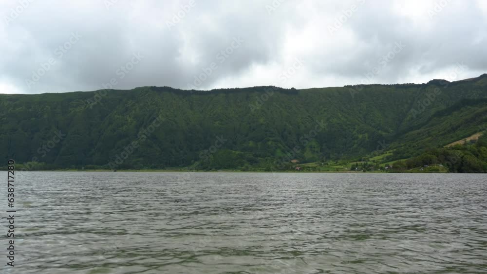 Volcanic hills at the shore of the Blue lake in San Miguel Island, Azores, Portugal Volcanic hills at the shore of the Blue lake in San Miguel Island, Azores, Portugal