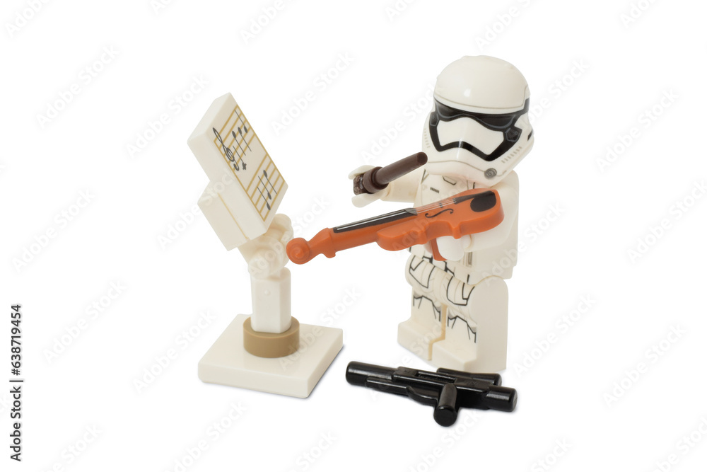 Fototapeta premium Lego minifigure of stormtrooper Star Wars is playing a violin as stop war concept. Editorial illustrative image of popular plastic toy constructor.
