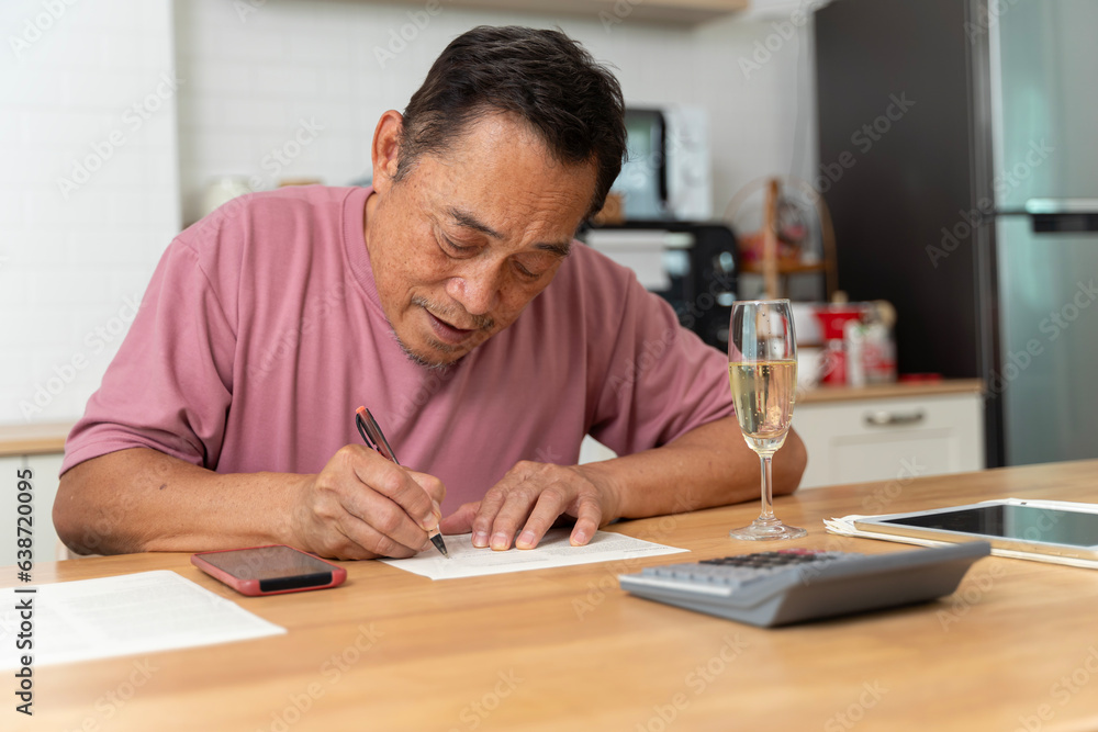 Portrait of handsome man sit on sofa arm on chin look interested notebook write down notes list to do indoors. Close Up of a senior man writing a letter. Portrait of handsome man sit on sofa arm on chin look interested notebook write down notes list to do indoors. Close Up of a senior man writing a letter.