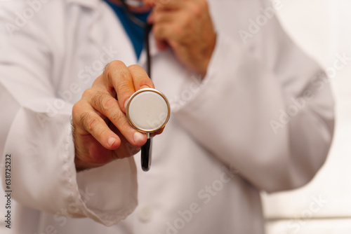 close-up of a doctor holding a stethoscope in his hand with the background out of focus