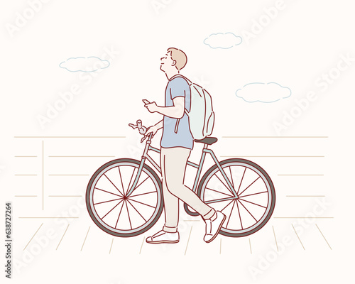A smiling smart casual man pushes a bike on the street and uses his phone. Hand drawn style vector design illustrations.