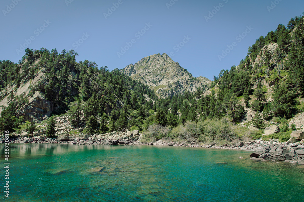 Beautiful idyllic lake next to a mountain during a summer day