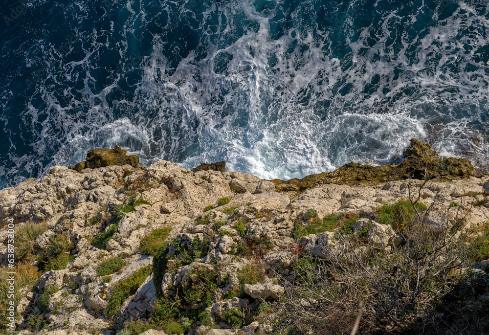 View on breaking waves down from cliff View on breaking waves down from cliff