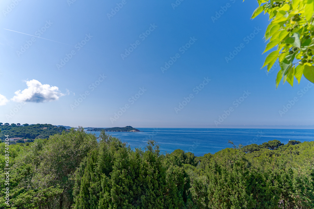 Aerial view of Mediterranean Sea seen from viewpoint of village of Giens with sailing boats in the background on a sunny late spring day. Photo taken June 10th, 2023, Giens, Hyères, France.