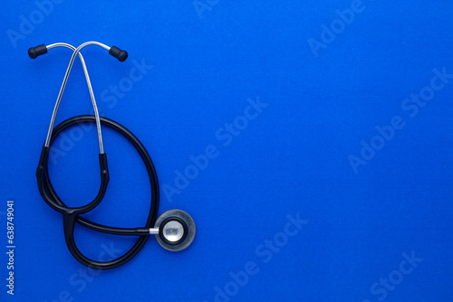 Medical Stethoscope isolated on blue background. Flat lay, top view.