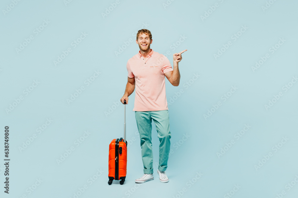 Traveler man wear casual clothes hold bag point aside isolated on pastel plain light blue cyan background studio Tourist travel abroad in free spare time rest getaway. Air flight trip journey concept Traveler man wear casual clothes hold bag point aside isolated on pastel plain light blue cyan background studio Tourist travel abroad in free spare time rest getaway. Air flight trip journey concept