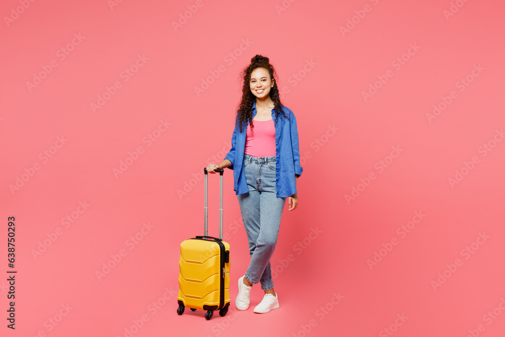 Traveler smiling woman wears blue shirt casual clothes hold suitcase isolated on plain pink background studio. Tourist travel abroad in free spare time rest getaway. Air flight trip journey concept. Traveler smiling woman wears blue shirt casual clothes hold suitcase isolated on plain pink background studio. Tourist travel abroad in free spare time rest getaway. Air flight trip journey concept.