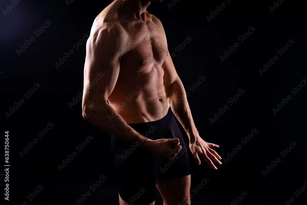 Fototapeta premium Man athlete isolated on black, red, white background. Fitness motivation.
