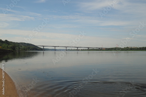 River landscape in summer. Sandy beach and bridge over the river. High quality photo