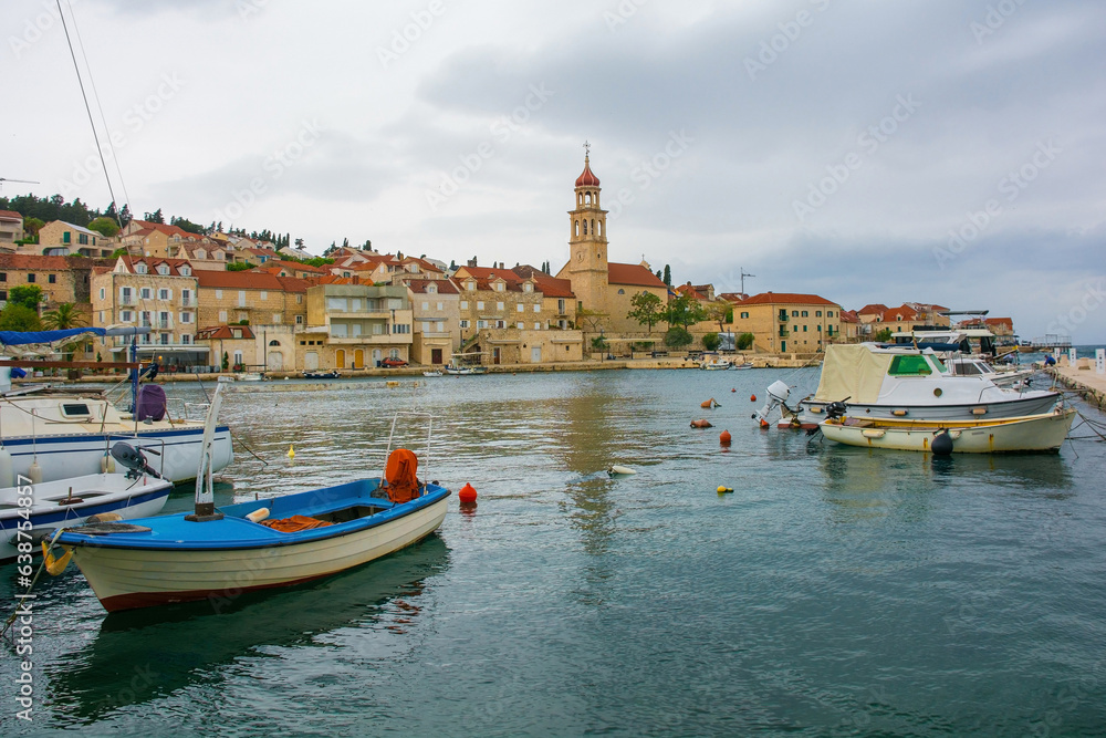 The harbour of the historic village of Sutivan on Brac Island in Croatia. The Church of the Assumption of the Blessed Virgin Mary is centre
