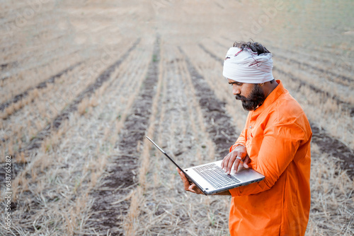 Young indian farmer in depression after see some detail in laptop.