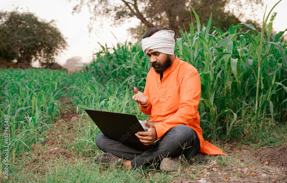 Young indian farmer in depression after see some detail in laptop. Young indian farmer in depression after see some detail in laptop.