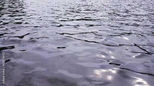 Surface of a river peacefully flowing through stepping stones at Woldaecheon in Jeju Island, South Korea