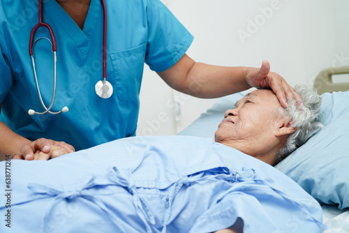 Asia doctor with stethoscope checking elderly woman patient in hospital, healthy medical concept.