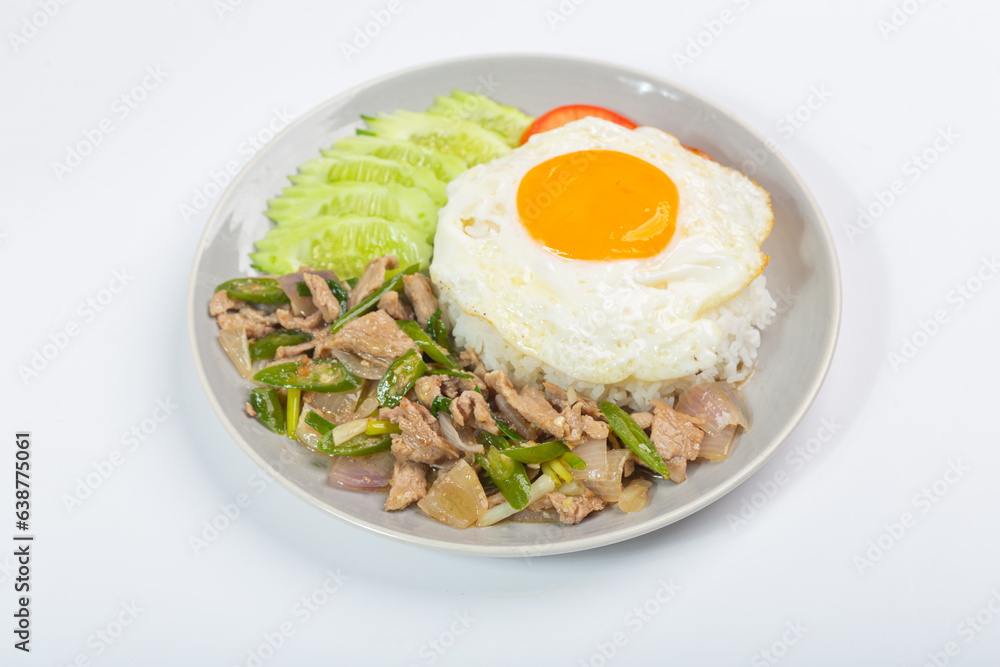 Fried pork with green chili, fried egg and cucumber on white background Fried pork with green chili, fried egg and cucumber on white background