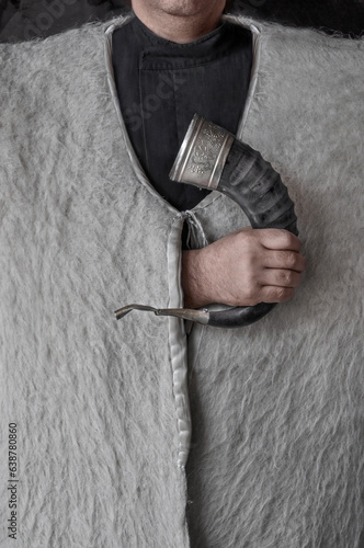 georgian man in national woolen clothes shepherds burka with drinking horn in hand